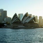 View of Sydney Opera House from across the Harbour in the sunset 