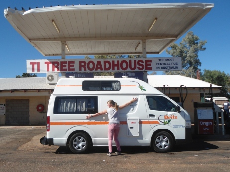 Hugging a campervan as it is filled up with petrol at a roadhouse in Ti Tree in the Northern Territory 