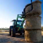 Tractor stacking bales of hay 