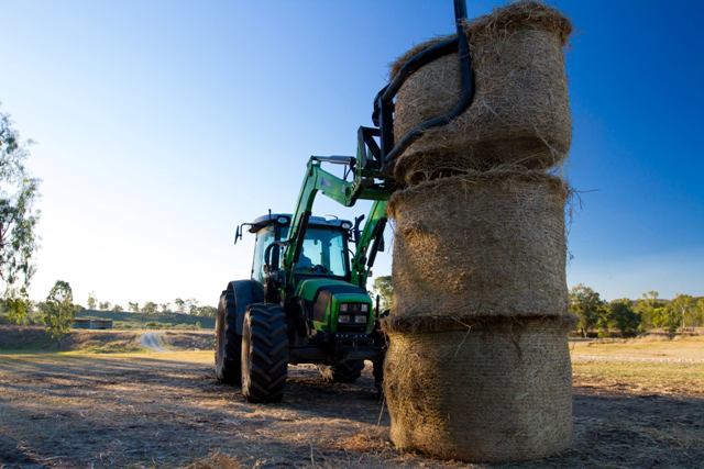 Stacking haybales with a tractor 