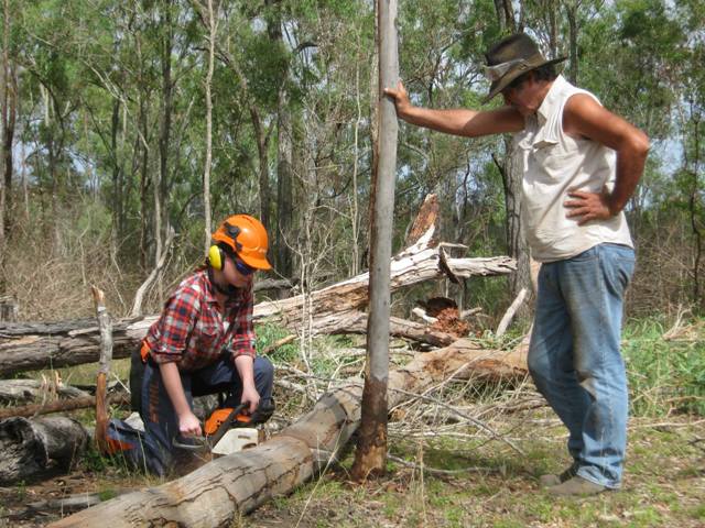 Girl learning chainsaw skills 