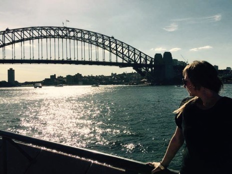 Georgie looking out to the Sydney Harbour Bridge at Sunset across the water from the back of the Opera House 