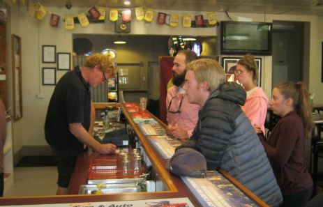 Backpackers ordering drinks at a local outback pub