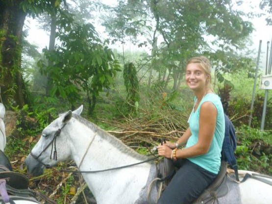 Volunteer on a horse in Costa Rican rainforest