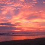 Very red and orange cloudy sky with the sunset over the sea