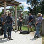 Group stands and listens to a talk about safety in the yards