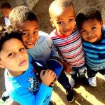 Children on the sports coaching programme in South Africa smile happily at the camera