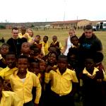 Kids and volunteers pose for a picture