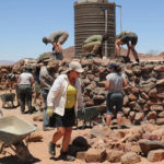 A group of volunteers working amongst the rubble in the desert