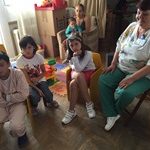 A doctor and children at the hospital enjoy relaxing together