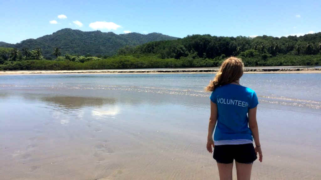 A volunteer looks out over the beach in Costa Rica