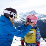 Whistler Kid having helmet fitted by instructor