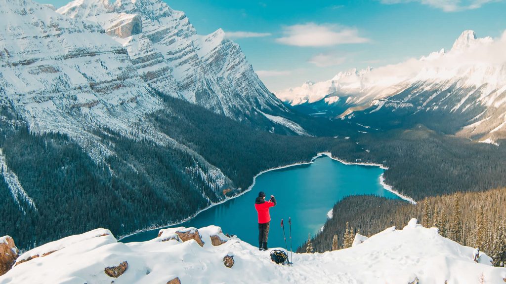 A hiker enjoys the stunning view over Peyto Lake in Banff National Park