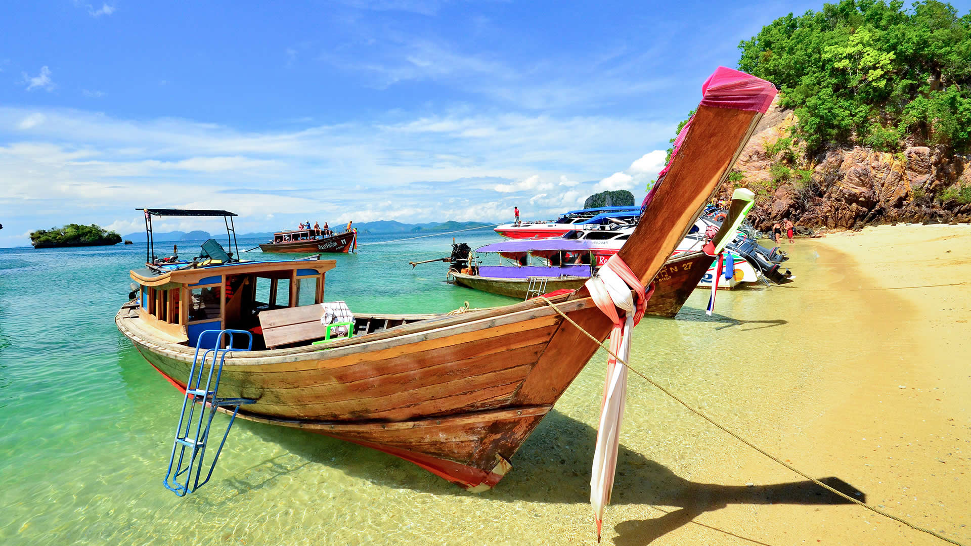 Traditional Thai boat on the beach of a paradise island