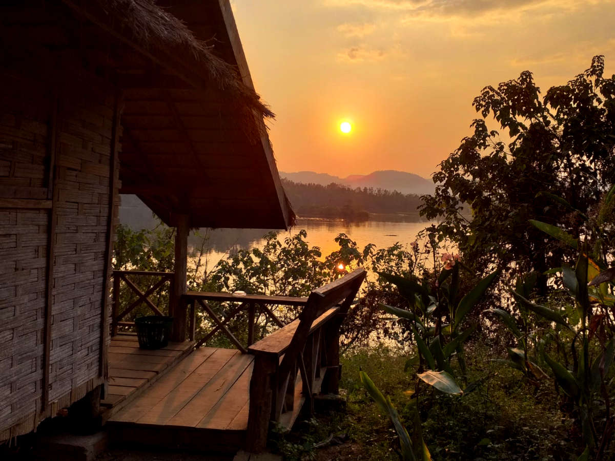 The sun sets over the lake at the elephant volunteering project in Laos