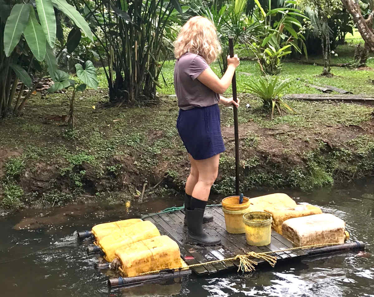 A volunteer paddles out to a monkey rehabilitation island in Ecuador