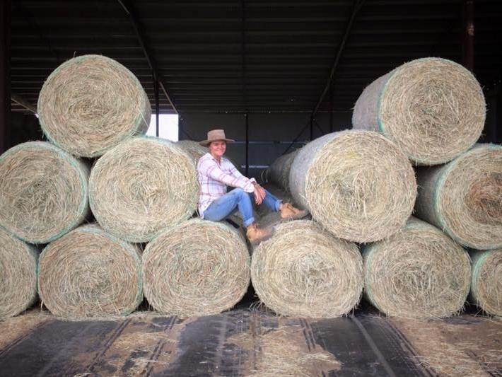 Girl sitting on hay bales 