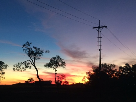 Sunset scene with telegraph pole in silhouette in scene