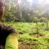 Volunteer showing her hard work replanting trees in the rainforest