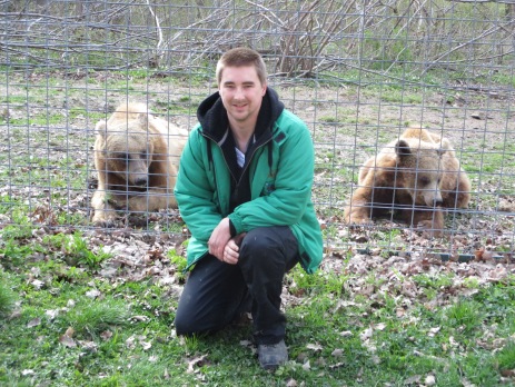 Luke Wililams, a volunteer in Romania, posing with a couple of the resident brown bears. 