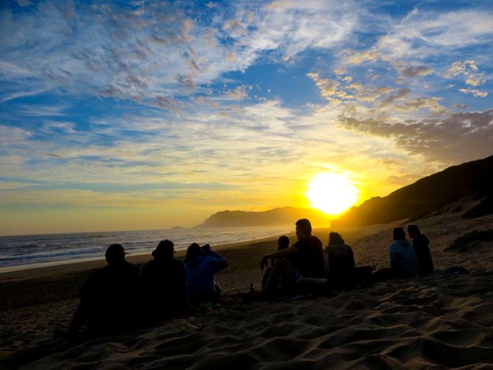 Travellers watch an amazing sunset on the Garden Route Adventure Tour