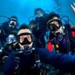 Volunteers pose for a selfie whilst diving in Thailand