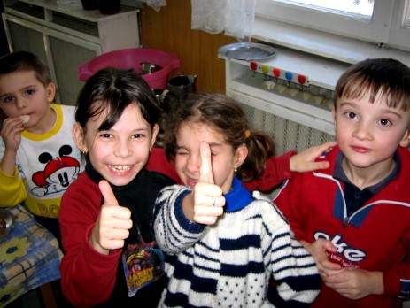 Children in the family home smile for the camera