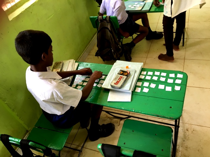 A Sri Lankan boy tries the exercises given to him by volunteer teachers