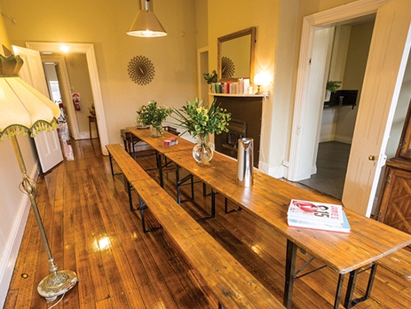 View of the Montacute boutique bunkhouse communal area in Hobart. Upmarket hostel with polished timber floors and modern decor 