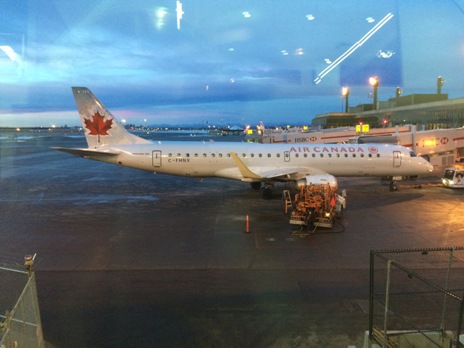 Photo of an Air Canada plane at the airport. Combat jet-lag on the plane and prepare yourself for when you arrive into the country. 