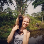 A volunteer with a monkey in Ecuador