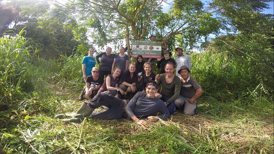 Team with the sign volunteering in Borneo